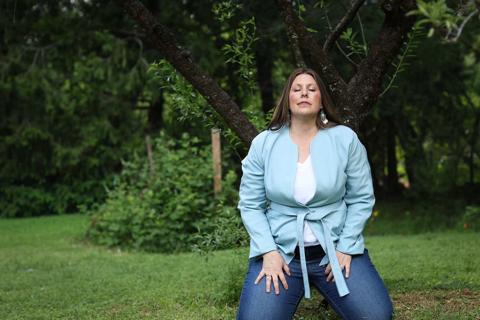 Amanda Smith grounding outdoors during Body Whisper Healing work focused on body awareness and inherited patterns.